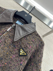 Leather-trimmed lapel knit zip-up jacket.