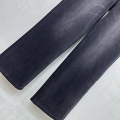 Pleated and distressed denim trousers