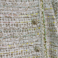 A light beige tweed blend short-sleeved jacket