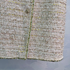 A light beige tweed blend short-sleeved jacket