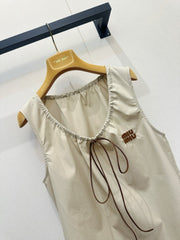 Beige vest dress with contrasting leather label