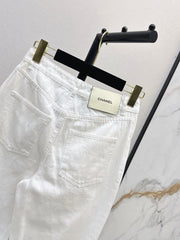 Slim-fit denim trousers with gold buttons