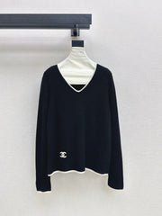 Black-and-white color-block V-neck knit top
