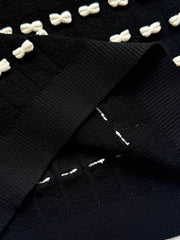 Knot-patterned long-sleeved knit sweater