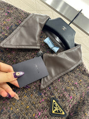 Leather-trimmed lapel knit zip-up jacket.