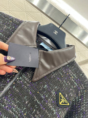 Leather-trimmed lapel knit zip-up jacket.