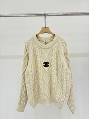 Oversized sweater with diamond cable knit pattern