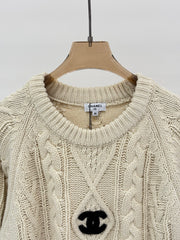 Oversized sweater with diamond cable knit pattern