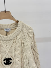 Oversized sweater with diamond cable knit pattern