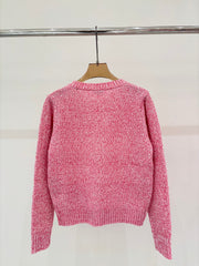 Sweater with small pockets at the hem
