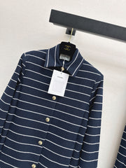A navy blue coat with beige pinstripes and a lapel collar