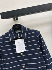 A navy blue coat with beige pinstripes and a lapel collar