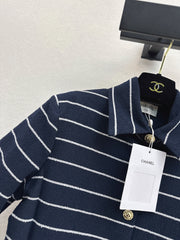 A navy blue coat with beige pinstripes and a lapel collar