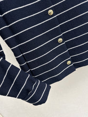 A navy blue coat with beige pinstripes and a lapel collar