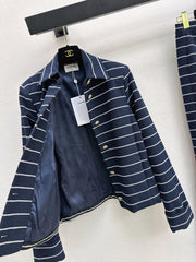 A navy blue coat with beige pinstripes and a lapel collar
