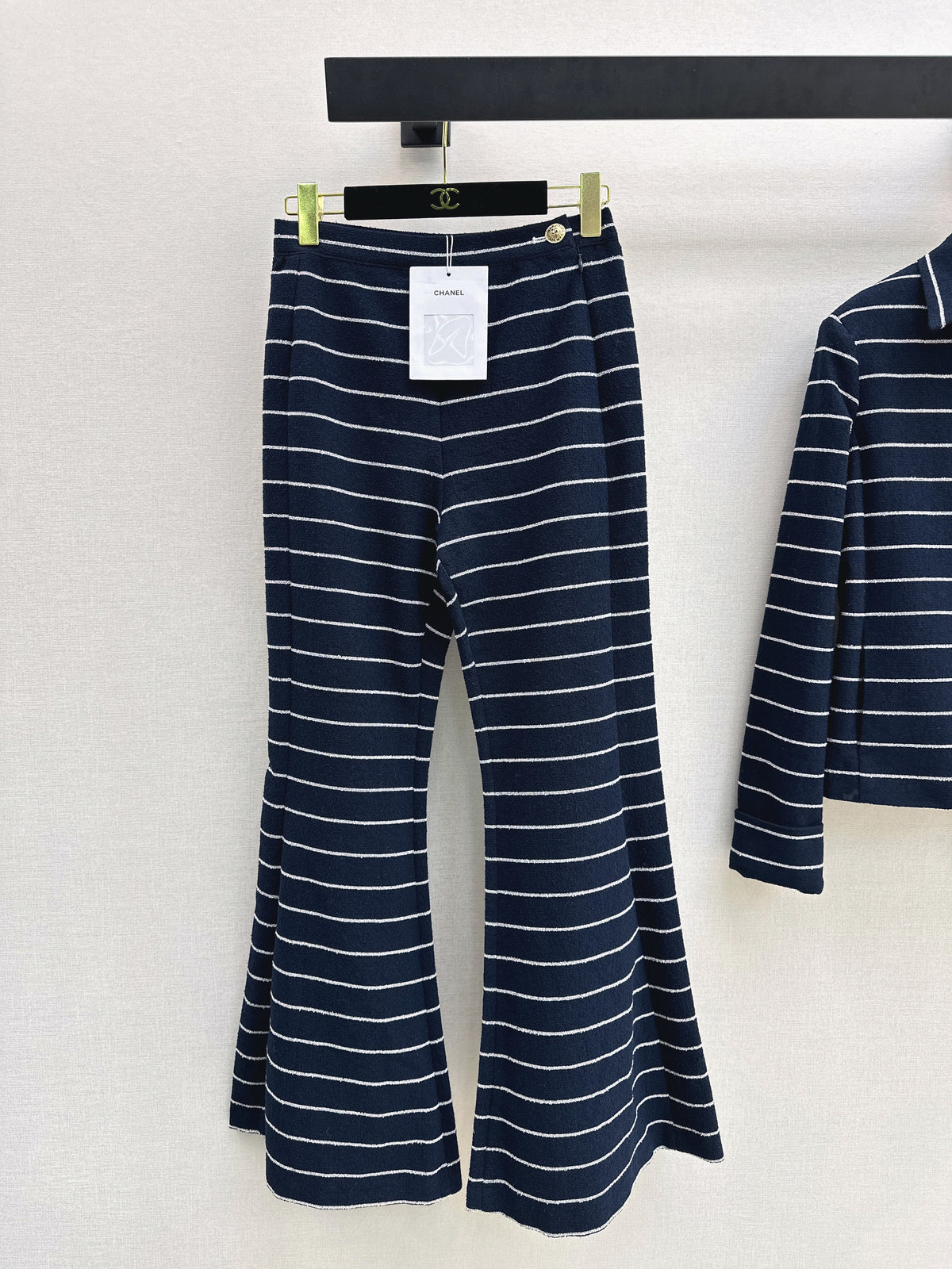 Navy blue flared trousers with beige pinstripes