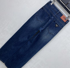 Pleated and distressed denim trousers