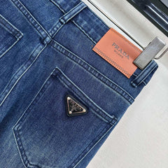 Pleated and distressed denim trousers