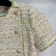 A light beige tweed blend short-sleeved jacket