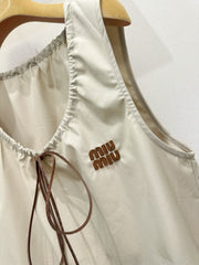 Beige vest dress with contrasting leather label