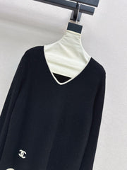 Black-and-white color-block V-neck knit top