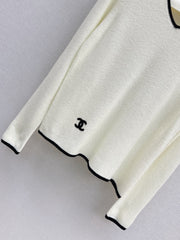 Black-and-white color-block V-neck knit top